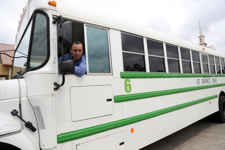 Pastor Tony Spell talks to the media as he drives a bus of congregants after his Easter church services on April 12, 2020 in Central, Louisiana (Chris Graythen/Getty Images)