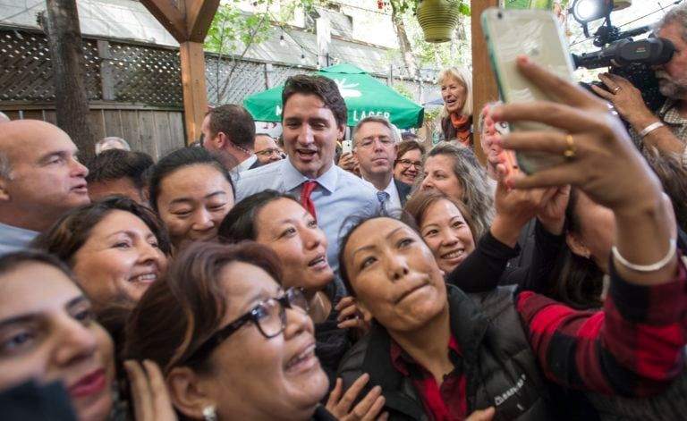 A group of supporters gather around Trudeau during a campaign stop in Toronto on Oct. 13, 2015 (CP/Paul Chiasson)