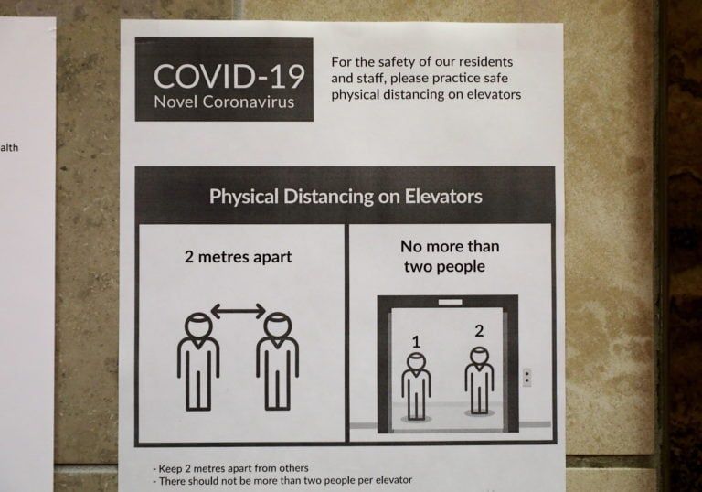 A sign urging physical distancing when using elevators is seen in a high-rise building in downtown Toronto on May 8, 2020. (Colin Perkel/CP)