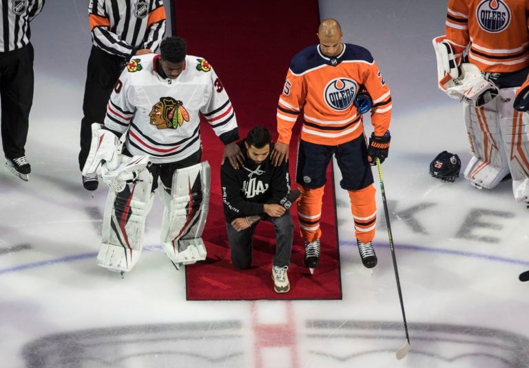 Dumba takes a knee during the U.S. national anthem, flanked by Nurse, right, and Subban. (Jason Franson/CP)