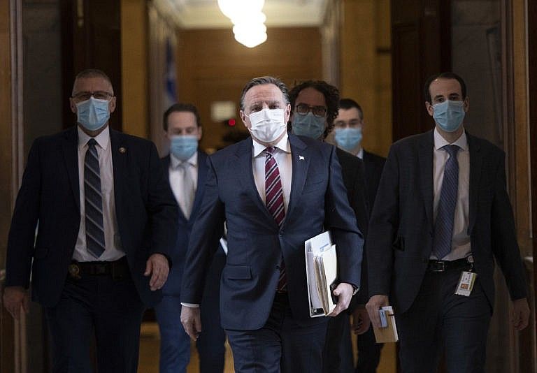 Legault walks to Question Period with members of his staff as the legislature resumes for its spring session on Feb. 2, 2021 in Quebec City (CP/Jacques Boissinot)