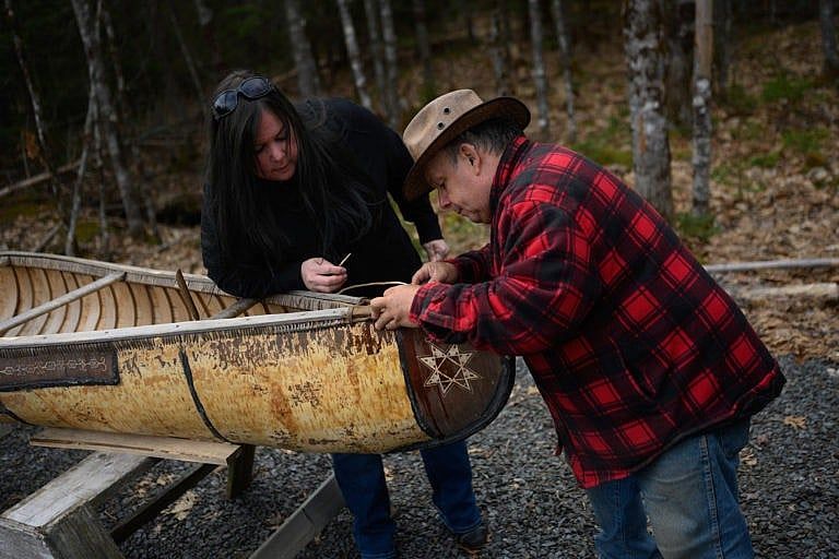 Mi’kmaq Elder Labrador (right) and his daughter, Melissa, repair a traditional birchbark canoe at his home in Conquerall Bank, N.S.(Photograph by Darren Calabrese)
