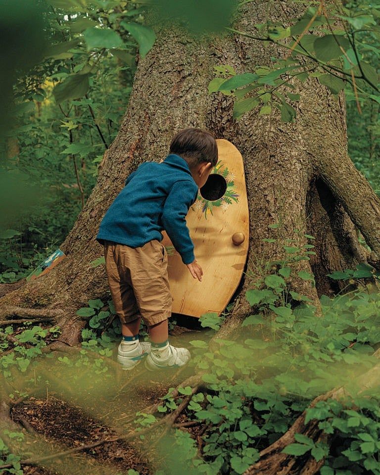 A young Guelphite stops to investigate a fairy door in Marksam Park’s ‘Friendly Folk Forest’ (Photograph by Brendan George Ko)