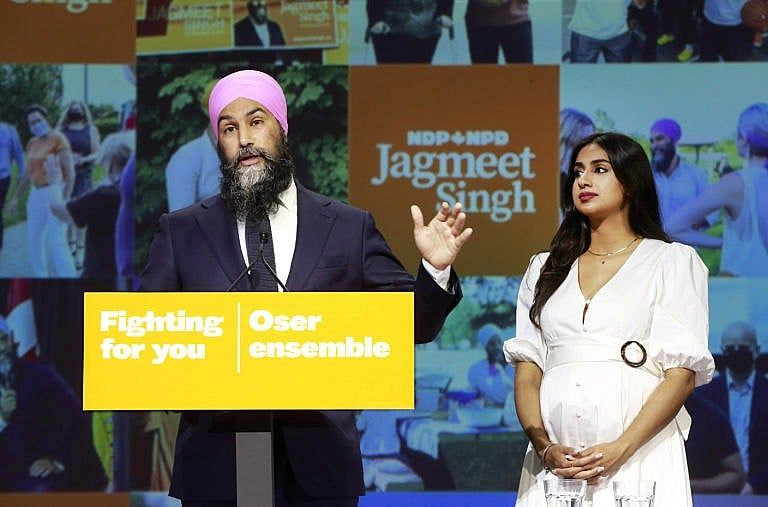 NDP Leader Jagmeet Singh stands with his wife Gurkiran Kaur Sidhu as he delivers remarks at an election night event on September 20, 2021 in Vancouver, Canada. For the first time in a decade, the New Democratic Party will have more seats in parliament than they had at the start of the election, picking up an additional three seats for a projected total of 27. (Jeff Vinnick/Getty Images)