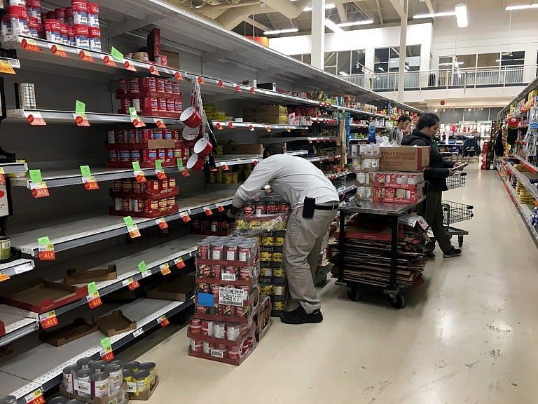 Workers restock shelves at a grocery store in Toronto early in the pandemic. (Frank Gunn/CP)