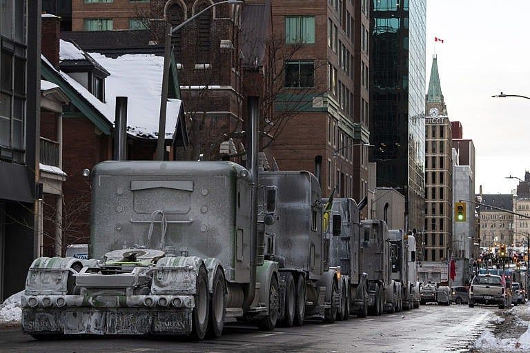 Trucks are parked on Metcalfe Street as a rally against COVID-19 restrictions, Ottawa, Jan. 30, 2022. (Justin Tang/The Canadian Press)