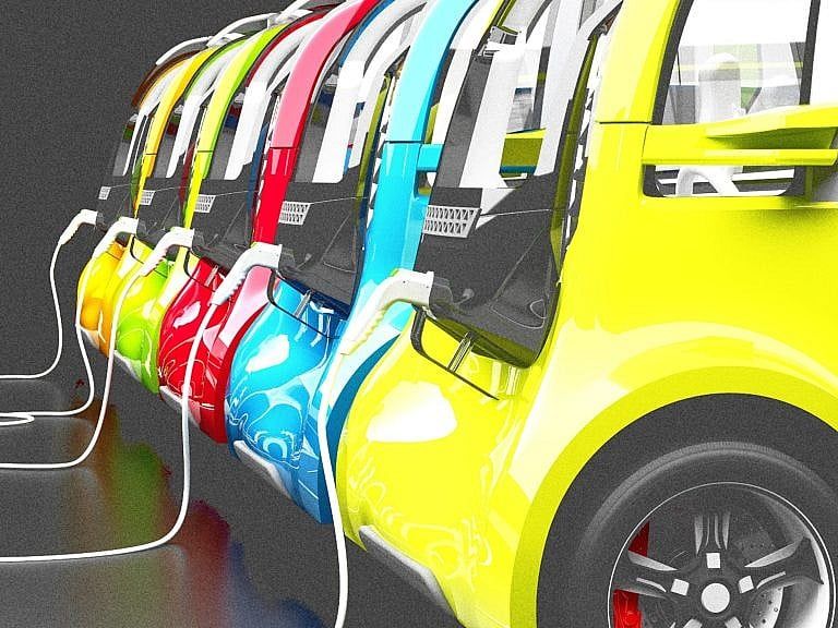 A row of electric vehicles in bright colours.