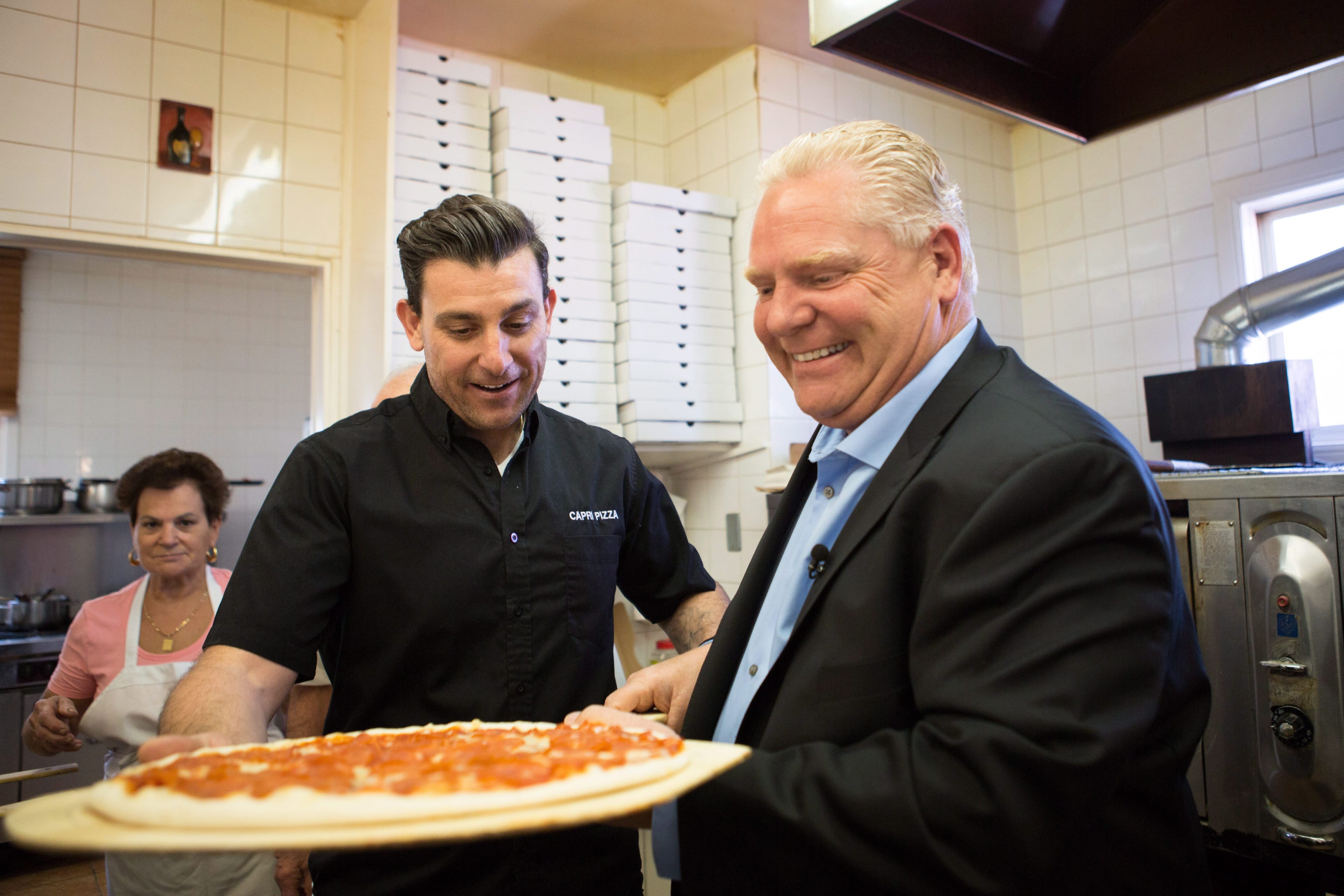 Ontario PC leader Doug Ford helps bake pizzas before an announcement at Capri Pizza during a campaign stop in Cambridge, Ont., on Thursday, May 17, 2018. (THE CANADIAN PRESS/Andrew Ryan)