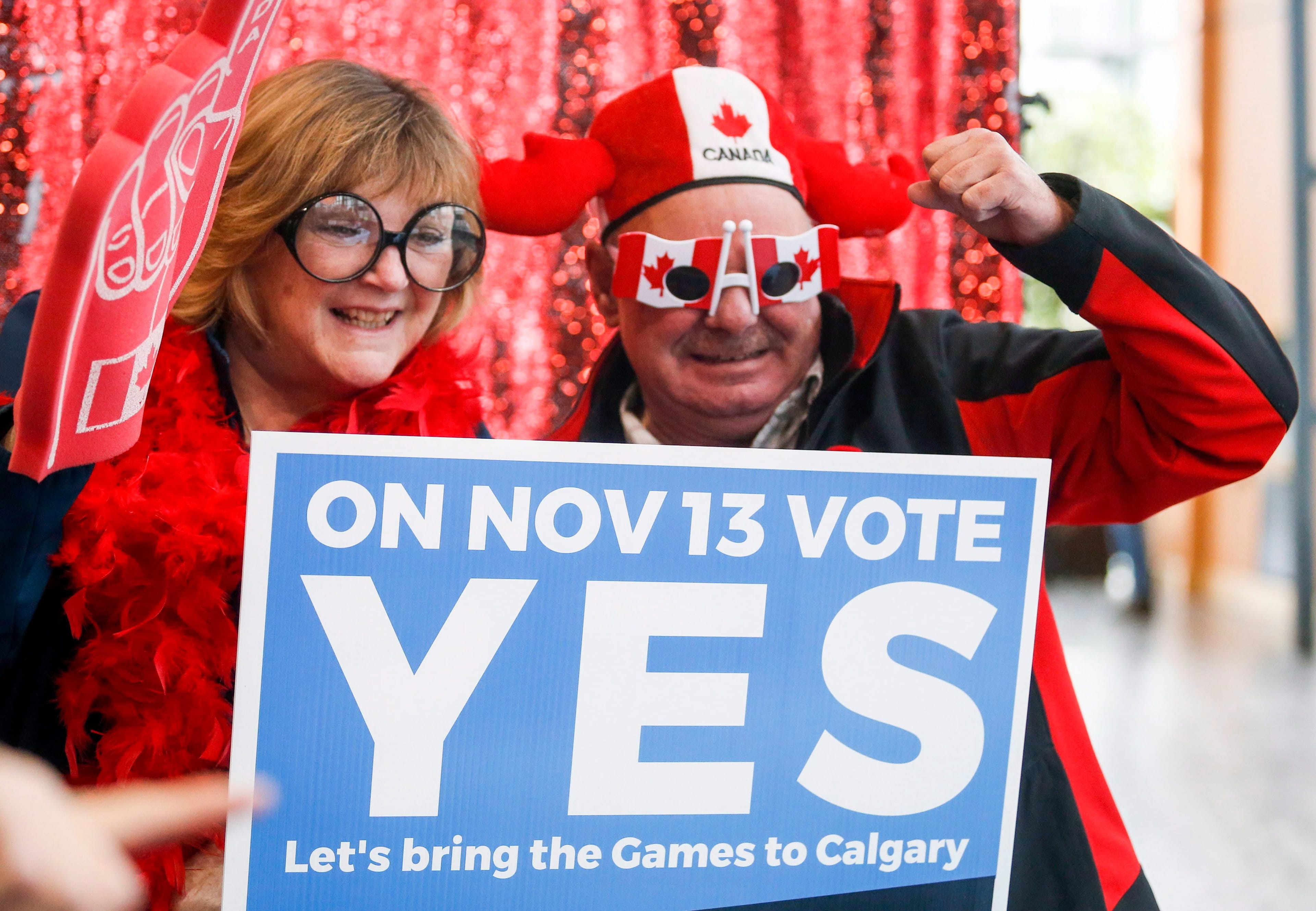 Calgary 2026 Olympic bid supporters pose in a photo booth during a rally in Calgary on Monday, Nov. 5, 2018. (THE CANADIAN PRESS/Jeff McIntosh)