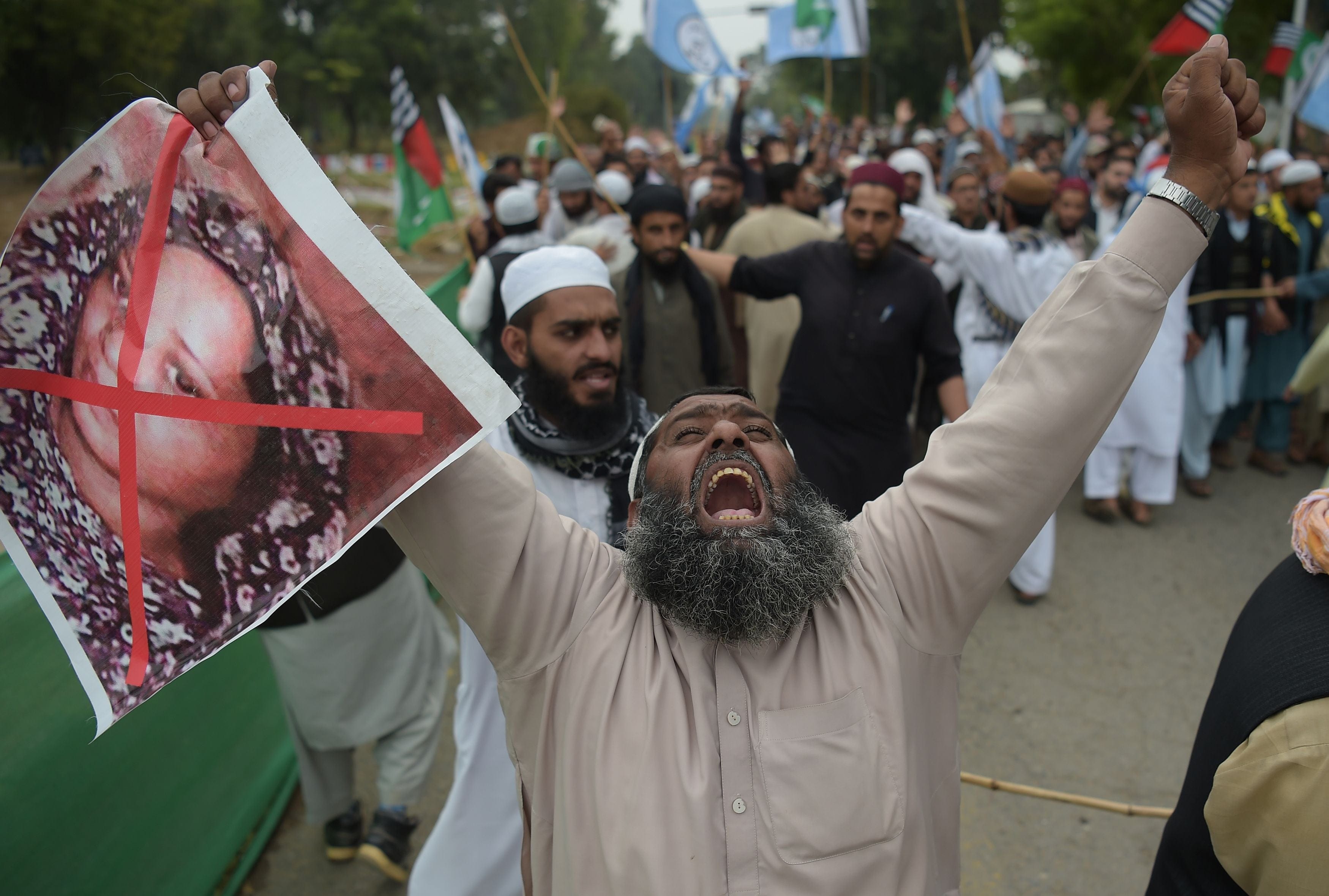 A supporter of the hardline religious party Ahle Sunnat Wal Jamaat holds an image of Asia Bibi during a protest rally following the Supreme Court's decision to acquit Bibi of blasphemy, in Islamabad on Nov. 2, 2018. (AAMIR QURESHI/AFP/Getty Images)