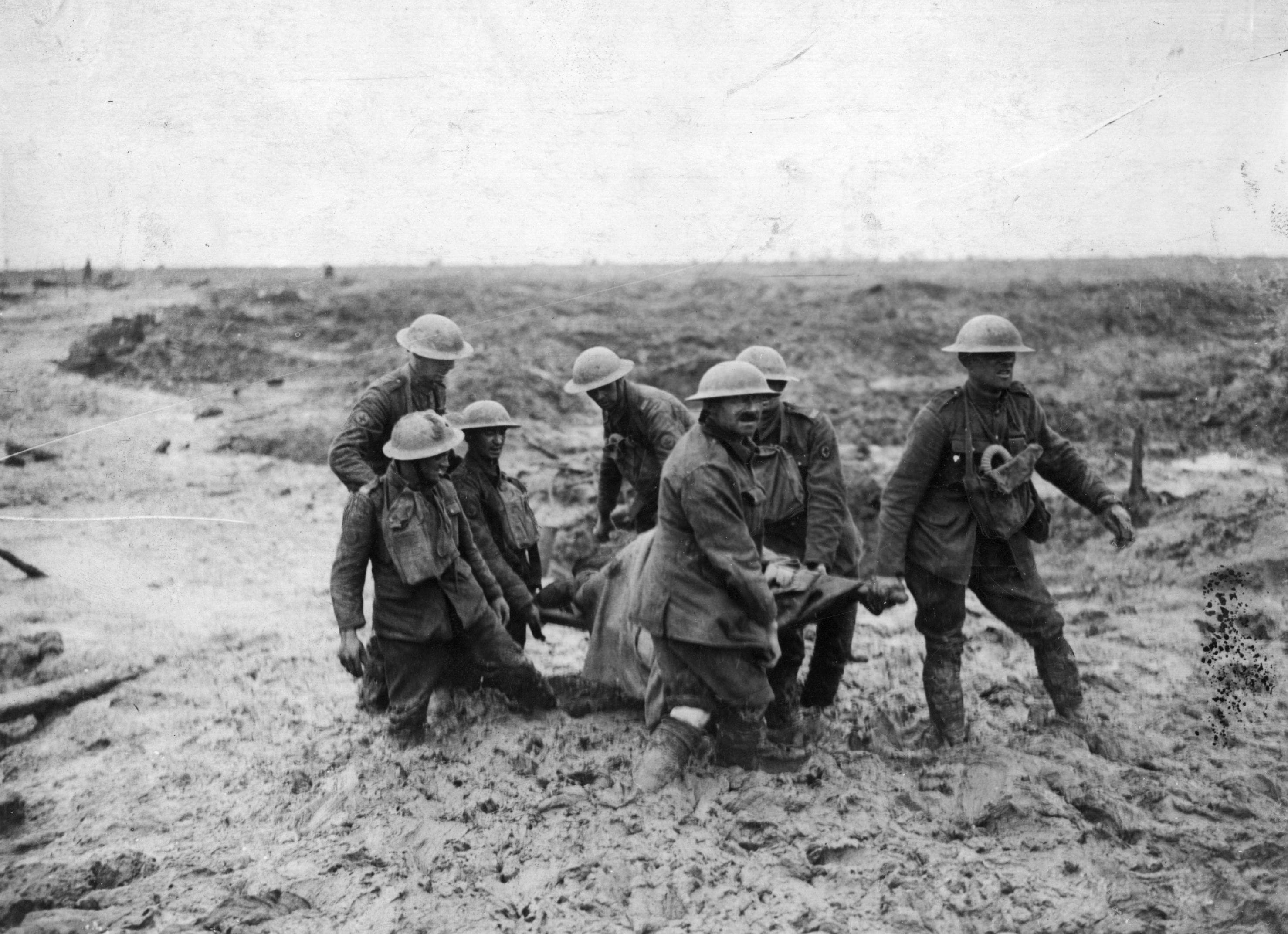 A stretcher-bearing party carrying a wounded soldier through the mud near Boesinghe during the battle of Passchendaele in Flanders. (John Warwick Brooke/Getty Images)