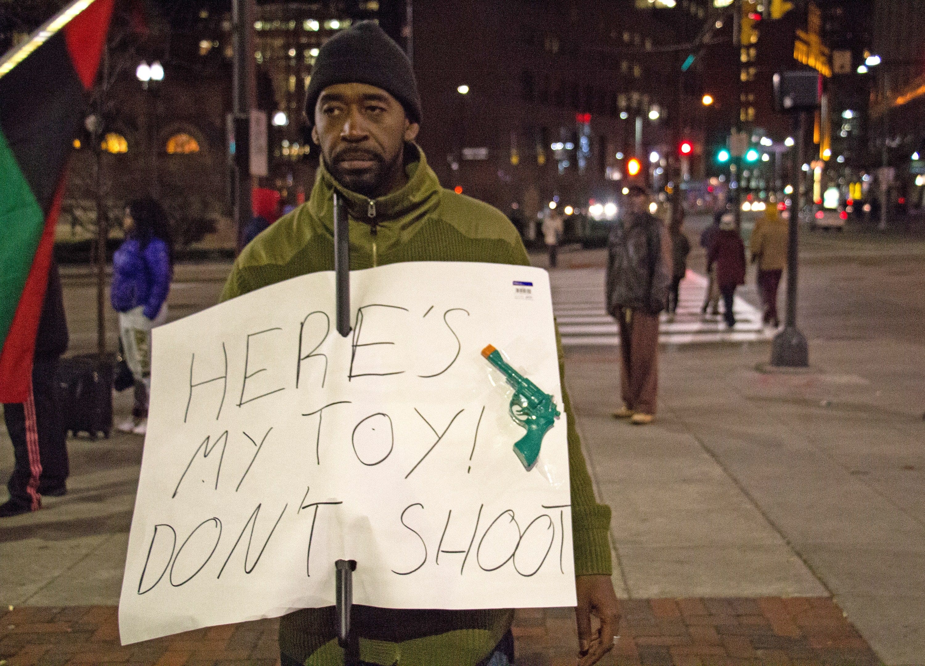 A man holds a sign in Cleveland, Ohio, on Nov. 25, 2014, referring to the fatal shooting of 12-year-old Tamir Rice (Jordan Gonzalez/AFP/Getty Images)