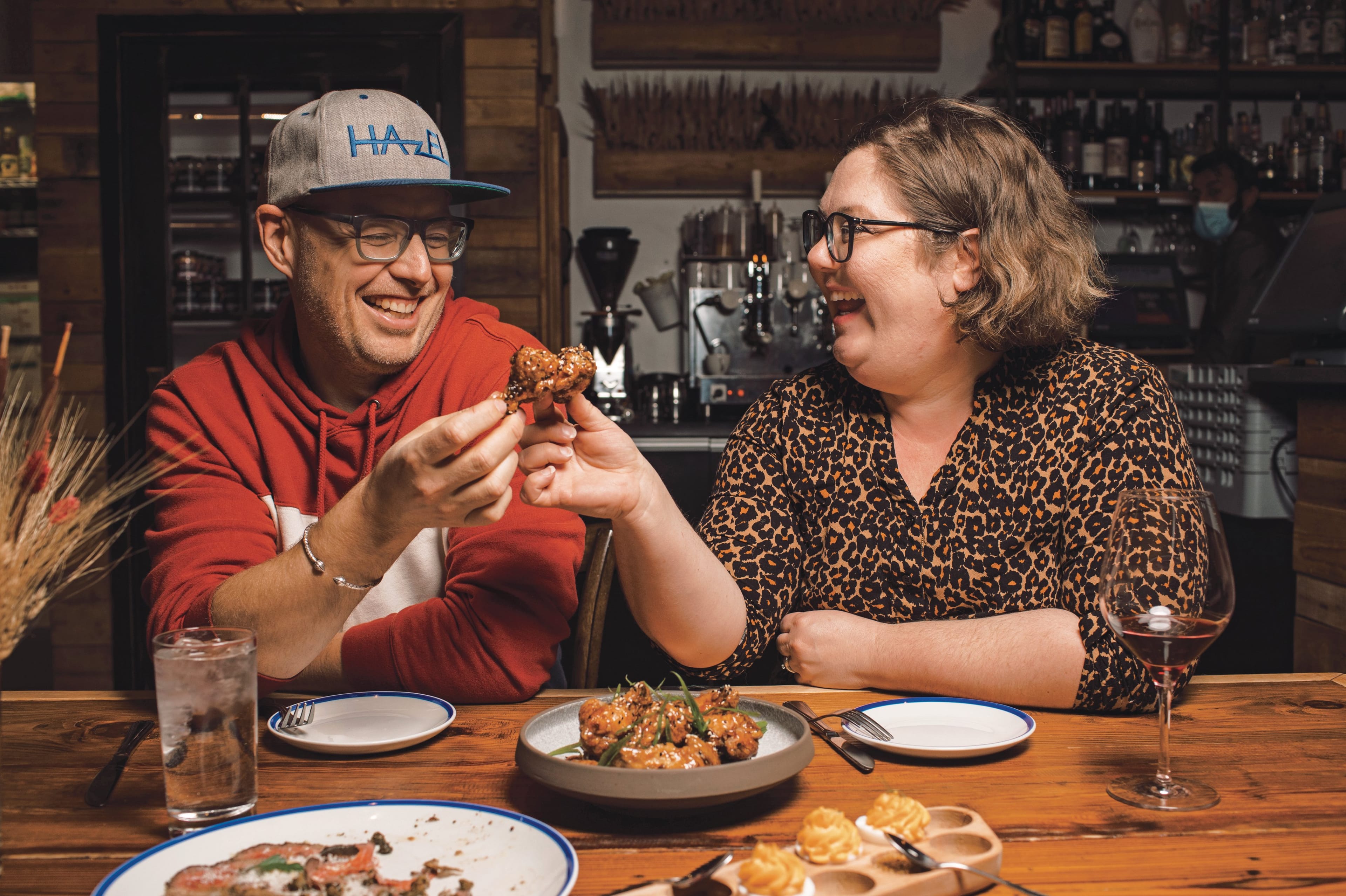 Seale and Jackson enjoy chicken wings at the Workshop Eatery in Edmonton, Alta. (Photograph by Amber Bracken)