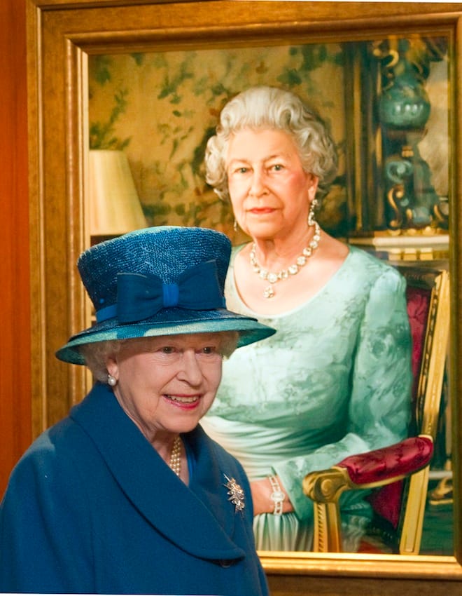 Britain's Queen Elizabeth passes a portrait of herself as she tours the new liner 'Queen Elizabeth', before the official naming ceremony at the Ocean terminal, in Southampton