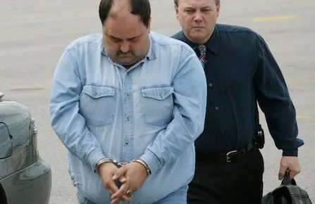 Nelson Lloyd Hart, 36, is escorted to court in Gander, Nfld., on Monday, June 13, 2005. Hart is charged with two counts of first-degree murder in the deaths of three-year-olds Karen and Krista in August 2002. (CP PHOTO/Scott Cook)