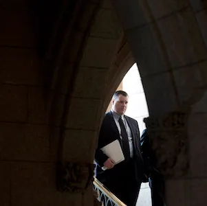 Canadian Heritage and Official Languages Minister James Moore walks to a news conference to discuss victims and crime Thursday Dec.13, 2012 in the foyer of the House of Commons Thursday December 13, 2012 in Ottawa. THE CANADIAN PRESS/Adrian Wyld
