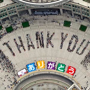 An aerial view shows people sitting in formation to the words "thank you" and displaying signs that collectively read "Arigato" (Thank You) during an event celebrating Tokyo being chosen to host the 2020 Olympic Games, at Tokyo Metropolitan Government Building in Tokyo, in this photo taken by Kyodo September 8, 2013. Tokyo was awarded the 2020 summer Olympic Games on Saturday, beating Istanbul in a head-to-head vote after Japanese Prime Minister Shinzo Abe delivered a charismatic plea to the International Olympic Committee and promised Japan's crippled nuclear plant was "under control." (Kyodo/Reuters)
(JAPAN - Tags: SPORT OLYMPICS POLITICS) ATTENTION EDITORS - THIS IMAGE HAS BEEN SUPPLIED BY A THIRD PARTY. IT IS DISTRIBUTED, EXACTLY AS RECEIVED BY REUTERS, AS A SERVICE TO CLIENTS. FOR EDITORIAL USE ONLY. NOT FOR SALE FOR MARKETING OR ADVERTISING CAMPAIGNS. MANDATORY CREDIT. JAPAN OUT. NO COMMERCIAL OR EDITORIAL SALES IN JAPAN - RTX13CKF