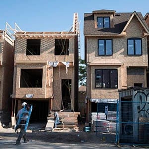 Houses are shown under construction in Toronto on Friday, June 26, 2015. Canada Mortgage and Housing Corp. expects the country's housing markets to moderate. (Graeme Roy/CP)