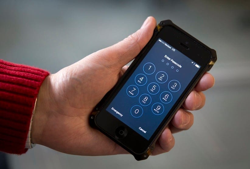 An iPhone is seen in Washington, Wednesday, Feb. 17, 2016. A U.S. magistrate judge has ordered Apple to help the FBI break into a work-issued iPhone used by one of the two gunmen in the mass shooting in San Bernardino, California, a significant legal victory for the Justice Department in an ongoing policy battle between digital privacy and national security. Apple CEO Tim Cook immediately objected, setting the stage for a high-stakes legal fight between Silicon Valley and the federal government. (AP Photo/Carolyn Kaster)