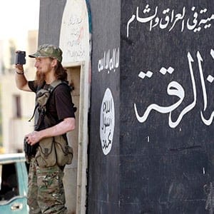 A militant Islamist fighter uses a mobile to film his fellow fighters taking part in a military parade along the streets of Syria's northern Raqqa province June 30, 2014. The fighters held the parade to celebrate their declaration of an Islamic "caliphate" after the group captured territory in neighbouring Iraq, a monitoring service said. The Islamic State, an al Qaeda offshoot previously known as Islamic State in Iraq and the Levant (ISIL), posted pictures online on Sunday of people waving black flags from cars and holding guns in the air, the SITE monitoring service said. (Reuters)
