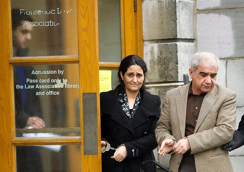 Mohammad Shafia, right, Tooba Yahya, centre, and their son Hamed Shafia, left, are escorted during a lunch break at the Frontenac County courthouse in Kingston, Ontario on Friday, January 27, 2012. (Nathan Denette/CP)