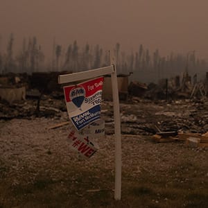 Thick smoke hangs over burnt homes along Prospect Drive in Fort McMurray's Timberlea neighbourhood as wildfires continue to burn out of control in northern Alberta on Sunday, May 15, 2016. (Photograph by Amber Bracken)