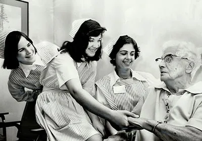 Teenage Volunteers at Toronto Western Hospital give their attention to 81-years-old patient Mrs. Williamina Bruce. The girls; all 14 years old; are from left; Sara Carr; Marinella Sovran and Sandra Fant. The young volunteers are wearing the pink and white uniforms from which they get their name candy-stripers. (Bob Olsen/Toronto Star/Getty Images)