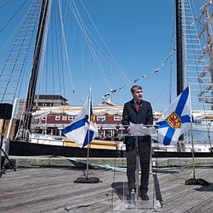 Nova Scotia Premier Stephen McNeil, left, announces that Halifax will be a 2017 Tall Ships Regatta venue coinciding with the province's Canada 150 celebration during a press conference on the waterfront in Halifax on Friday, May 13, 2016. (Darren Calabrese/CP)