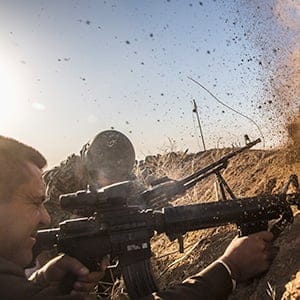 Kurdish pesh merga troops fire at Islamic State positions as they move toward the Iraqi town of Badana Pichwk on Monday morning, Oct. 17, 2016. Kurdish forces began Monday advancing on a string of villages east of Mosul, the start of a long-awaited campaign to reclaim Iraq's second-largest city from the Islamic State, which seized it more than two years ago, officials said. (Bryan Denton/The New York Times/Redux)