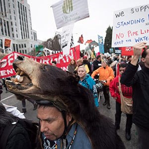 Thomas Terry, of the St'at'imc First Nation, wears a black bear hide during a protest march against the Kinder Morgan Trans Mountain Pipeline expansion, in Vancouver, B.C., on Saturday November 19, 2016. The proposed $5-billion expansion would nearly triple the capacity of the pipeline that carries crude oil from near Edmonton to the Vancouver area to be loaded on tankers and shipped overseas. A federal government decision on whether to approve the proposal is expected by December 19. (Darryl Dyck/CP)