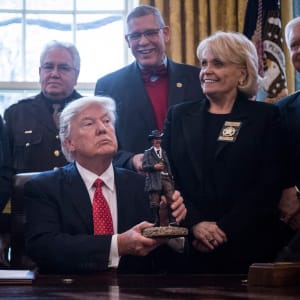 President Donald Trump holds a figurine given to him by a group of county sheriffs in the Oval Office of the White House in Washington, DC on Tuesday, Feb. 07, 2017. (Jabin Botsford/The Washington Post/Getty Images)