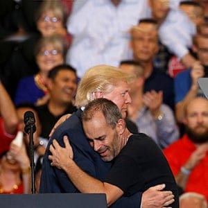 U.S. President Donald Trump hugs a supporter he invited onstage to speak during a "Make America Great Again" rally at Orlando Melbourne International Airport in Melbourne, Florida, U.S. February 18, 2017. (Kevin Lamarque/Reuters)