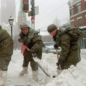 Members of The Royal Regiment of Canada (from left to right) Pte. Paul Roventa, Master Cpl. Gary Walters, Cpl. Kerry-Ann Cameron, and Pte. Phil Cheung shovel snow in downtown Toronto Friday, Jan.15, 1999. (KEVIN FRAYER/CP)