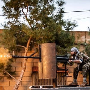 A fighter of the Kurdish People's Protection Units (YPG) fires an anti-aircraft weapon from Tel Tawil village in the direction of Islamic State fighters positioned in the countryside of the town of Tel Tamr February 25, 2015. (Rodi Said/Reuters)
