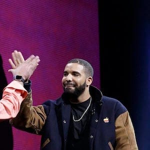 Musician Drake, right, high fives Eddy Cue, Apple senior vice president of Internet Software and Services, during the Apple Worldwide Developers Conference in San Francisco, Monday, June 8, 2015. The maker of iPods and iPhones announced Apple Music, an app that combines Beats 1, a 24-hour, seven-day live radio station, with an on-demand music streaming service. (AP Photo/Jeff Chiu)