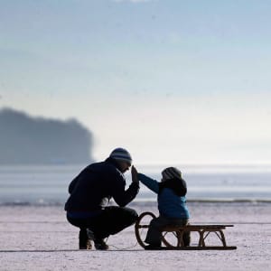 A father and his child enjoy walking on Lake Ammersee on January 28, 2017 in Stegen am Ammersee, Germany. After an unusual cold winter period currently most of the Bavarian lakes are completely or partly frozen. (Johannes Simon/Getty Images)