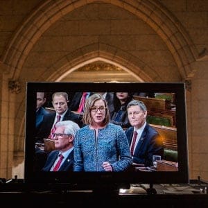 TV monitor outside House of Commons during Question Period Minister of Democratic Institutions showing Karina Gould. (Photograph by Peter Bregg)