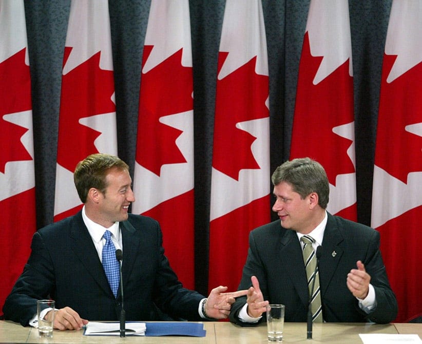 MacKay and Harper address the media at a news conference in Ottawa on Oct. 16, 2003 (CP/Jonathan Hayward)