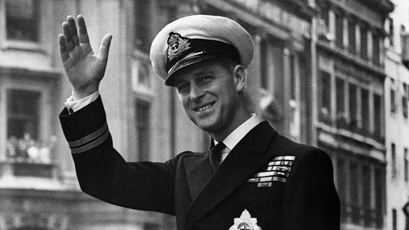 Prince Philip, Duke Of Edinburgh waving through the open roof of a car in 1948. (Central Press/Getty Images)