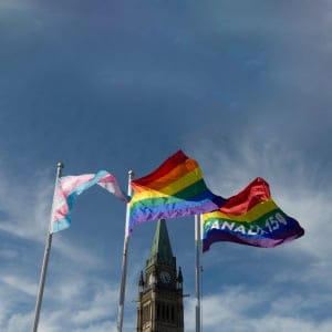The pride and transgender flags fly on Parliament Hill following a ceremony with Prime Minister Justin Trudeau in Ottawa, Wednesday June 14, 2017. (Adrian Wyld/CP)