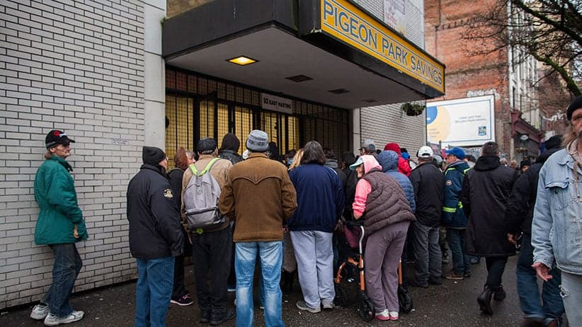 Crowd outside Pigeon Park Savings in Vancouver