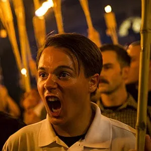 Peter Cvjetanovic (R) along with Neo Nazis, Alt-Right, and White Supremacists encircle and chant at counter protestors at the base of a statue of Thomas Jefferson after marching through the University of Virginia campus with torches in Charlottesville, Va., USA on August 11, 2017. (Samuel Corum/Anadolu Agency/Getty Images)
