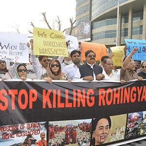 In Lahore, Pakistan, protesters carry a banner reading “stop killing rohingya muslims”