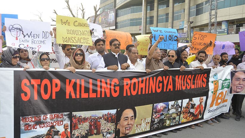 In Lahore, Pakistan, protesters carry a banner reading “stop killing rohingya muslims”