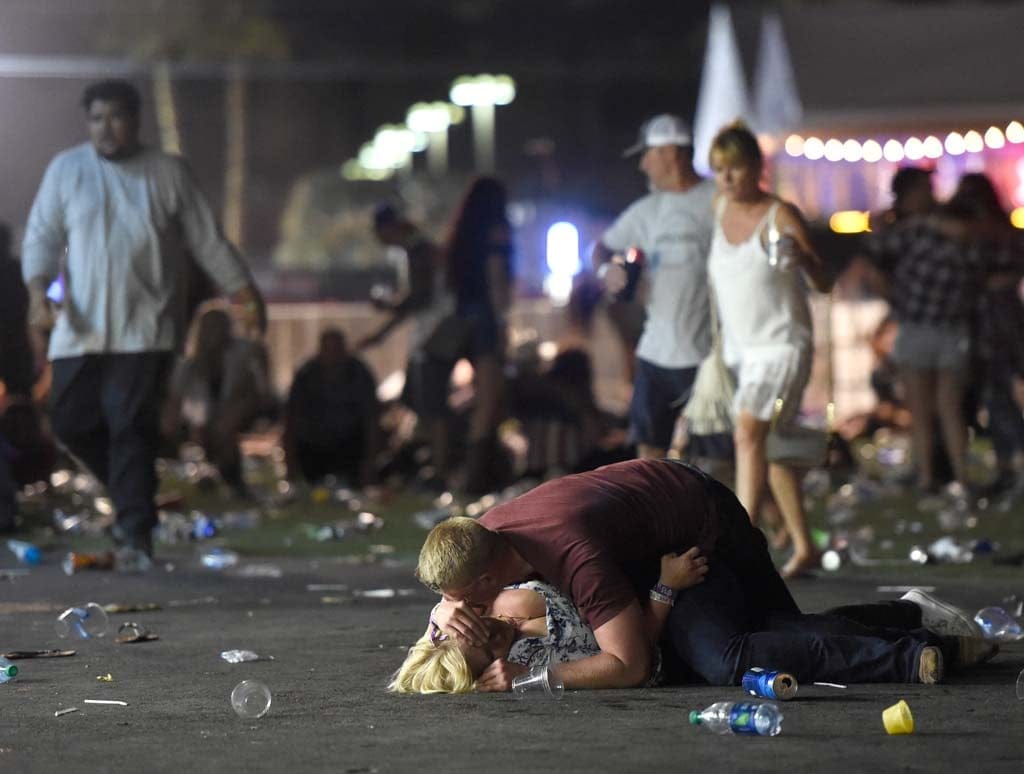 People lie on the ground at the Route 91 Harvest country music festival after apparent gun fire was hear on October 1, 2017 in Las Vegas, Nevada. There are reports of an active shooter around the Mandalay Bay Resort and Casino. (David Becker/Getty Images)