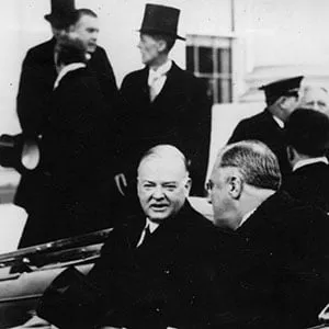 16th March 1933: Franklin Delano Roosevelt (1882 - 1945), the 32nd President of the United States of America (right) leaving the White House, Washington DC, for the Capitol on his inaugural day, with 31st President Herbert Clark Hoover (1874 - 1964) beside him in the limousine. (Topical Press Agency/Getty Images)