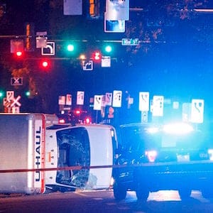Police investigate the scene after a cube van ran into pedestrians and later flipped over while being pursued by police, in Edmonton Alta, on Saturday September 30, 2017. THE CANADIAN PRESS/Jason Franson