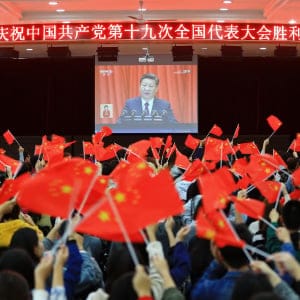 College students wave national flags as they watch the opening of the 19th Communist Party Congress in Huaibei in China's eastern Anhui province on October 18, 2017.
President Xi Jinping declared China is entering a "new era" of challenges and opportunities on October 18, as he opened a Communist Party congress expected to enhance his already formidable power. (AFP/Getty Images)