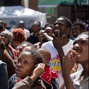 Haitian migrants seeking asylum in the United States, listen to announcements as they wait for their opportunity to get a spot at the Padre Chava soup kitchen and shelter in the Mexican border city of Tijuana, in Baja California, on October 6, 2016.
The National Human Rights Commission of Mexico (CNDH) on Saturday called on the government to support the saturated shelters and humanitarian centres for migrants in the border cities of Tijuana and Mexicali, where an increase in the arrival of Haitians and Africans hoping to be allowed to continue north to the United States has been registered. / AFP / Guillermo Arias (Photo credit should read GUILLERMO ARIAS/AFP/Getty Images)
