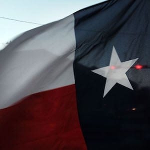 SWEETWATER, TX - JANUARY 19: The Texas flag flies in downtown Sweetwater on January 19, 2016 in Sweetwater, Texas. Global oil prices continue their downward fall with U.S. oil dropping towards $27 a barrel, its lowest since 2003, on worries about global oversupply. Following a diplomatic agreement on nuclear fuel with America, Iran has forecast it will add 500,000 barrels per day to global production, following the lifting of sanctions. (Photo by Spencer Platt/Getty Images)